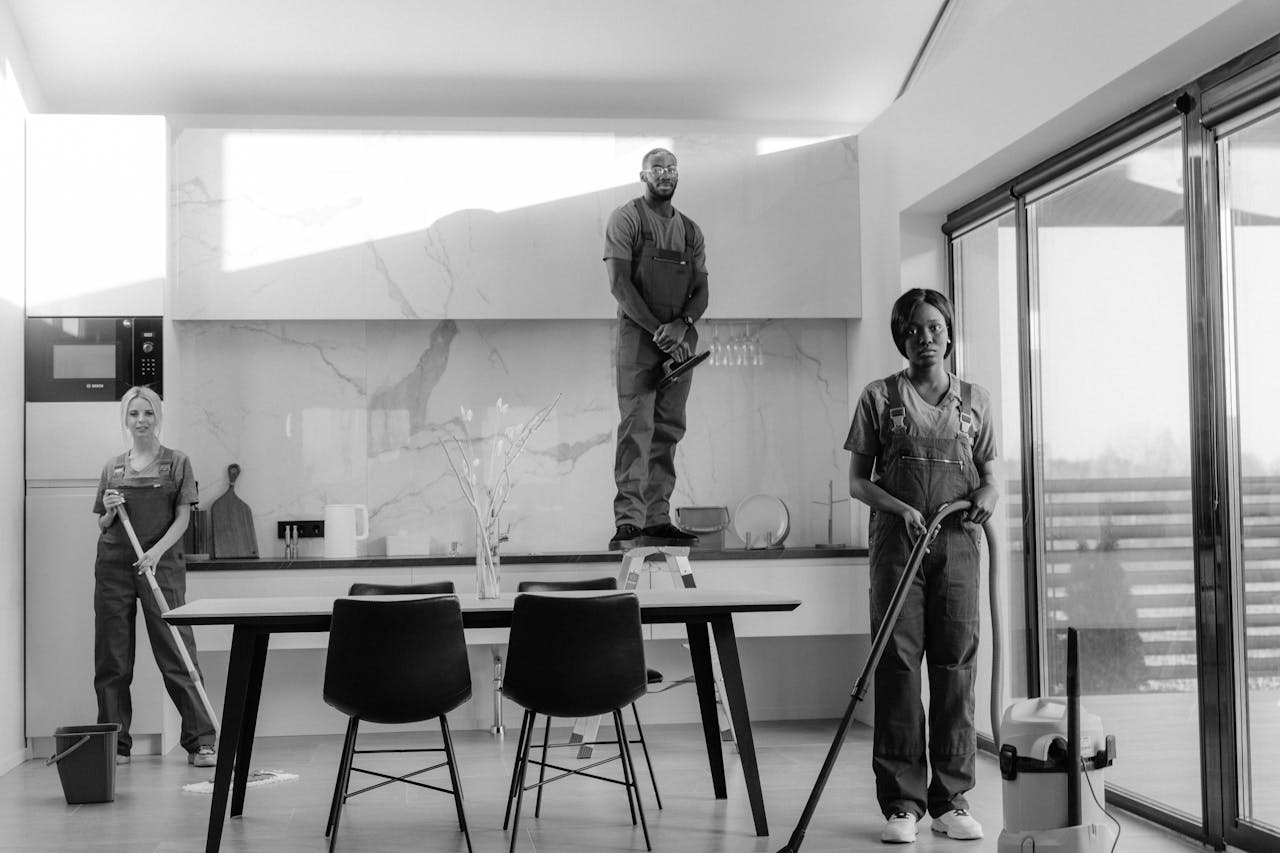about-01 A team of professional cleaners working in a modern dining room setting, enhancing interior cleanliness.